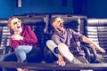 Guy and girl 3d glasses are very worried while watching a movie in a cinema