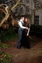 Couple in Victorian clothing embracing in the park Royalty Free Stock Photo