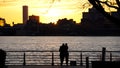 Couple with View on Jersey City from Manhattan during sunset. Royalty Free Stock Photo