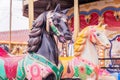 Couple of Vintage carousel horses. Merry-go-round in a holiday park