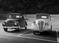 Couple of vintage cars in the parking lot of Sass Pordoi funicular, Italy