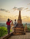 Couple visit Bagan Myanmar, hot air balloon during Sunrise above temples and pagodas of Bagan