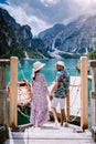 Couple visit the famous lake Lago Di Braies Italy, Pragser Wildsee in South Tyrol, Beautiful lake in the italian alps