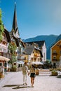 Couple visit Hallstatt village on Hallstatter lake in Austrian Alps Austria