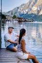 Couple visit Hallstatt village on Hallstatter lake in Austrian Alps Austria