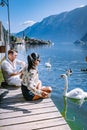 Couple visit Hallstatt village on Hallstatter lake in Austrian Alps Austria