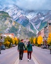 couple visit the town of Banff Alberta Canada, couple men and woman walking at the street of Banff with huge rocky Royalty Free Stock Photo