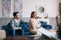 Couple visiting a psychologist and having a psychological session while dealing with problems in relationships. Royalty Free Stock Photo