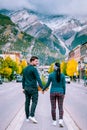 couple visit the town of Banff Alberta Canada, couple men and woman walking at the street of Banff with huge rocky Royalty Free Stock Photo