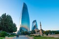 Couple walk with Flame towers in the cityscape in background. Panoramic view of Baku - the capital of Azerbaijan located by the