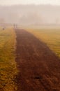 Couple walk in the mist Royalty Free Stock Photo