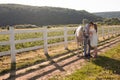 Couple walk at the ranch during summer day Royalty Free Stock Photo