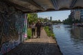 Couple walk under a bridge on the River Lea London