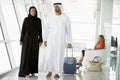 Couple walking through airport departure lounge Royalty Free Stock Photo