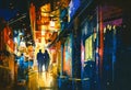 Couple walking in alley with colorful lights Royalty Free Stock Photo