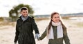 Couple walking along autumn beach