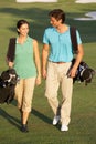 Couple Walking Along Golf Course Royalty Free Stock Photo