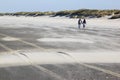 Couple walking on the Ameland Island Beach, Holland Royalty Free Stock Photo