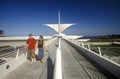 Couple walking around exterior of Milwaukee Art Museum on Lake Michigan, Milwaukee, WI