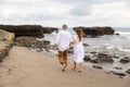 Couple walking barefoot along the beach. Back view. Romantic couple in love. Husband and wife travel together. Family relation Royalty Free Stock Photo