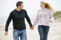 Couple walking at beach holding hands Royalty Free Stock Photo