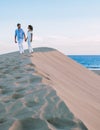 couple walking at the beach of Maspalomas Gran Canaria Spain, men and woman at the sand dunes desert Royalty Free Stock Photo