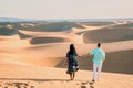 couple walking at the beach of Maspalomas Gran Canaria Spain, men and woman at the sand dunes desert of Maspalomas Royalty Free Stock Photo