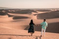 Couple walking at the beach of Maspalomas Gran Canaria Spain, men and woman at the sand dunes desert of Maspalomas Royalty Free Stock Photo