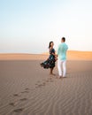 Couple walking at the beach of Maspalomas Gran Canaria Spain, men and woman at the sand dunes desert of Maspalomas