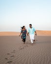 Couple walking at the beach of Maspalomas Gran Canaria Spain, men and woman at the sand dunes desert of Maspalomas Royalty Free Stock Photo