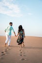 Couple walking at the beach of Maspalomas Gran Canaria Spain, men and woman at the sand dunes desert of Maspalomas Royalty Free Stock Photo