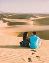 couple walking at the beach of Maspalomas Gran Canaria Spain, men and woman at the sand dunes desert Royalty Free Stock Photo