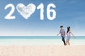 Couple walking at beach with numbers 2016 Royalty Free Stock Photo