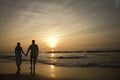 Couple Walking on Beach at Sunset