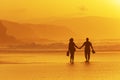 Couple walking on beach at sunset Royalty Free Stock Photo