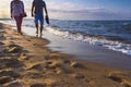 Couple walking on the beach at sunset light, Gdansk, Poland, relaxation concept Royalty Free Stock Photo