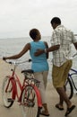 Couple Walking With Bicycles On Beach Royalty Free Stock Photo