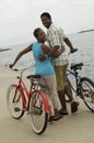 Couple Walking With Bicycles On Beach Royalty Free Stock Photo