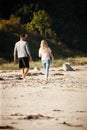 Couple, walking and bonding on outdoor beach sand, peace and travel to nature for holiday. People, back and calm stroll Royalty Free Stock Photo