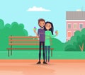 Couple walking in the city park and eating ice cream. Happy smiling girl and guy on date outdoors Royalty Free Stock Photo