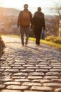 Couple walking on cobblestone foot path