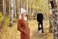 Couple walking with dog in the Park and hugging. Autumn walk men Royalty Free Stock Photo