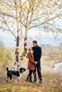 Couple walking with dog in the Park and hugging. Autumn walk men Royalty Free Stock Photo