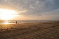 Couple walking the dog at sunrise