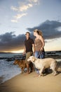 Couple Walking Dogs at the Beach Royalty Free Stock Photo