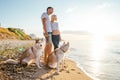 Couple walking with dogs on beach Royalty Free Stock Photo