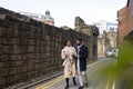 Couple Walking Down Back Lane Alongside City Walls Royalty Free Stock Photo