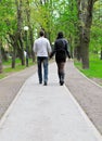 Couple walking down the road Royalty Free Stock Photo