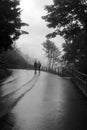 A couple walking down the road together in a raining day Royalty Free Stock Photo