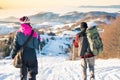 Couple walking down the snowy mountain in sunset time Royalty Free Stock Photo